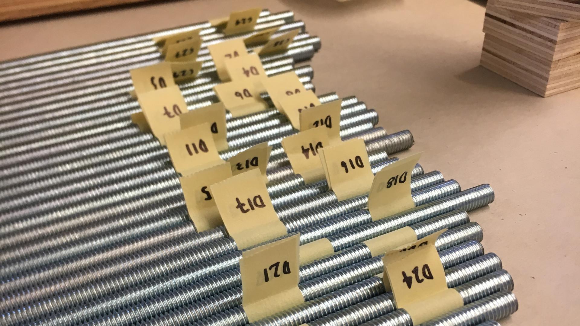 Metal rods labeled for assembly in the construction of the Kinetic DeLight installation.