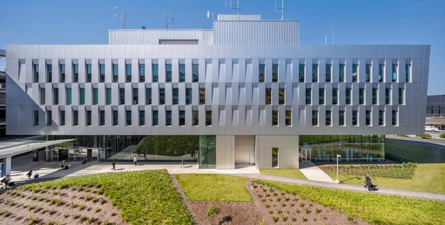 Exterior view of the PDX PACR operations building with planted landscaping in the foreground.